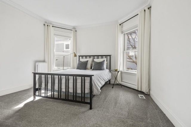 bedroom with visible vents, ornamental molding, baseboards, and carpet floors