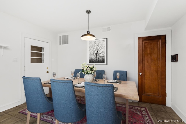 tiled dining space featuring visible vents