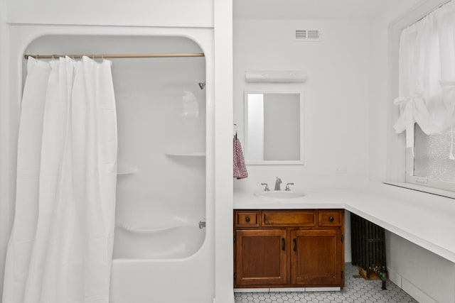 bathroom featuring visible vents, radiator, vanity, and tile patterned flooring