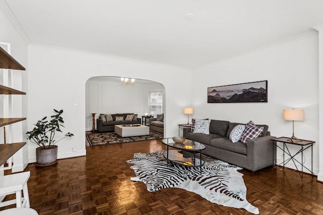 living room with arched walkways, a chandelier, crown molding, and baseboards