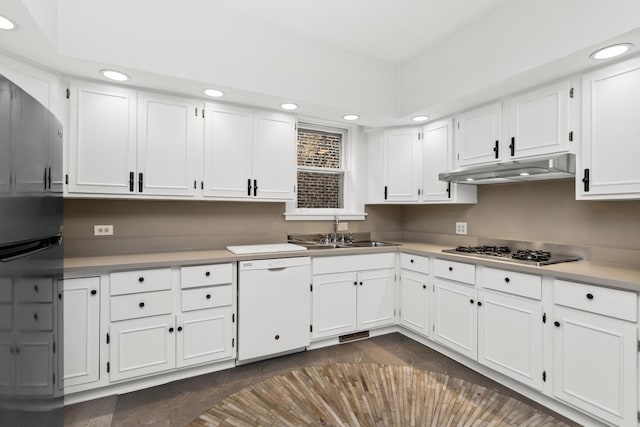 kitchen featuring a sink, under cabinet range hood, white cabinetry, dishwasher, and stainless steel gas cooktop