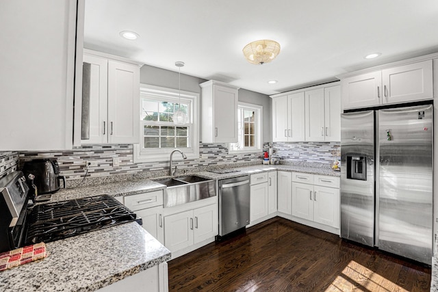 11551 S Justine St, Chicago, IL 60643 - kitchen featuring appliances with stainless steel finishes, backsplash, dark wood-style floors, light stone counters, and recessed lighting