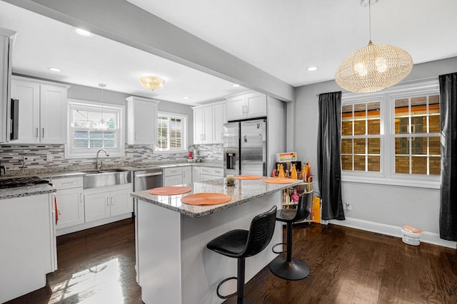 11551 S Justine St, Chicago, IL 60643 - kitchen with stainless steel appliances, dark wood finished floors, tasteful backsplash, light stone counters, and recessed lighting
