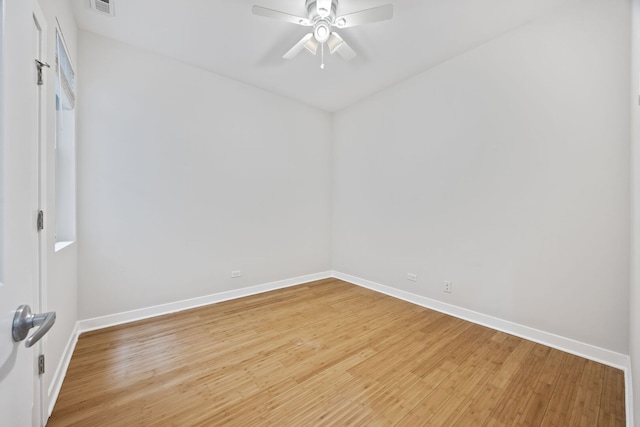 empty room featuring baseboards, light wood-style floors, and a ceiling fan