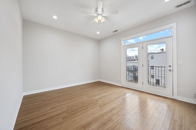 unfurnished room featuring visible vents, ceiling fan, baseboards, and light wood-style floors