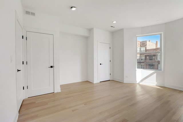 interior space with recessed lighting, light wood-style floors, visible vents, and baseboards