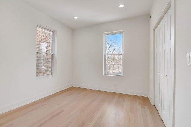 unfurnished bedroom featuring recessed lighting, baseboards, and light wood-style floors