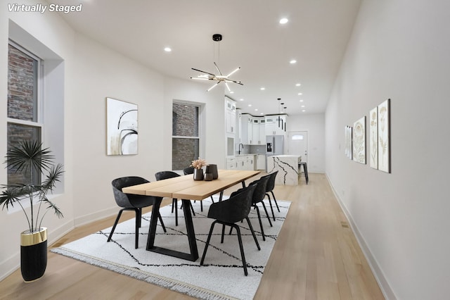 dining area featuring recessed lighting, light wood-type flooring, and baseboards