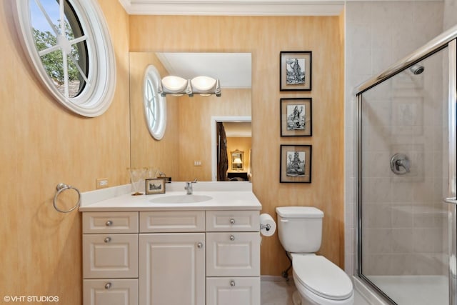 full bathroom featuring vanity, toilet, ornamental molding, and a shower stall