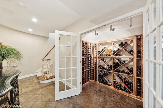 wine room featuring recessed lighting and baseboards