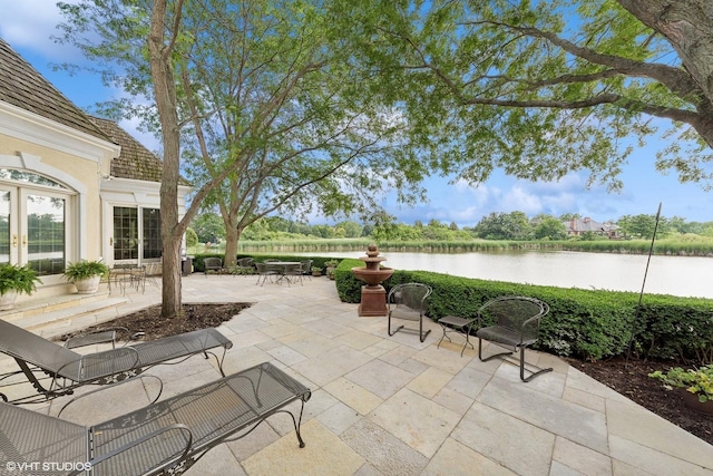 view of patio with a water view