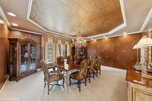 dining area with a tray ceiling, recessed lighting, a chandelier, and light carpet