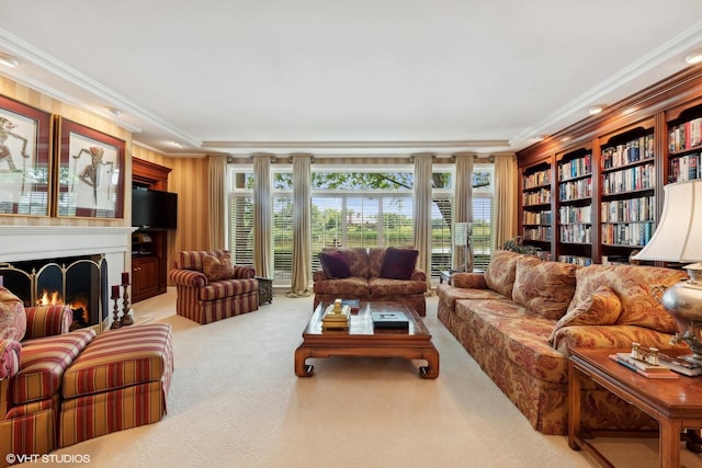 living room featuring carpet, a lit fireplace, and ornamental molding