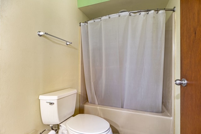 full bathroom featuring shower / bath combination with curtain and toilet