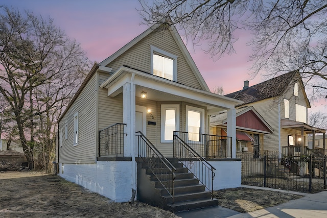 view of front of home featuring fence and covered porch