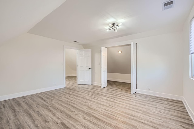 spare room with visible vents, baseboards, and light wood-style flooring