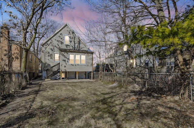 back of house with fence