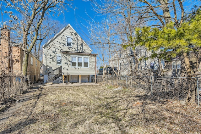 back of house with a carport and a fenced backyard