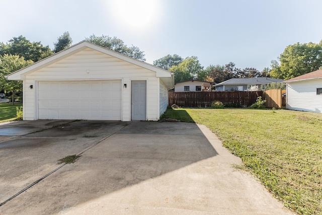 detached garage featuring fence