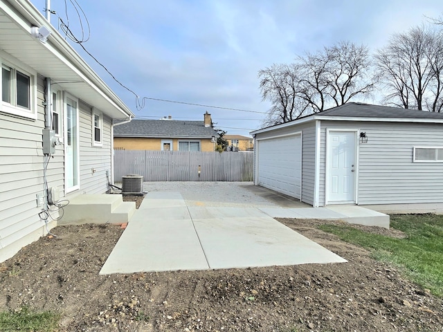 view of patio / terrace with an outbuilding and fence