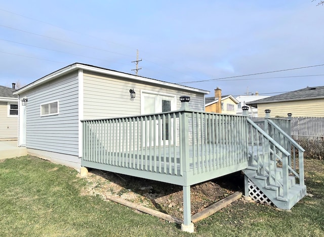 back of house featuring a yard, a wooden deck, and fence