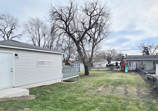 view of yard with an outbuilding and fence