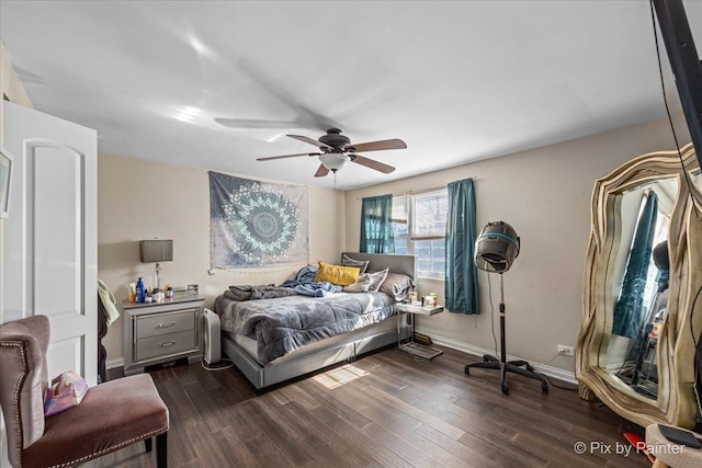 bedroom with a ceiling fan, dark wood-style floors, and baseboards