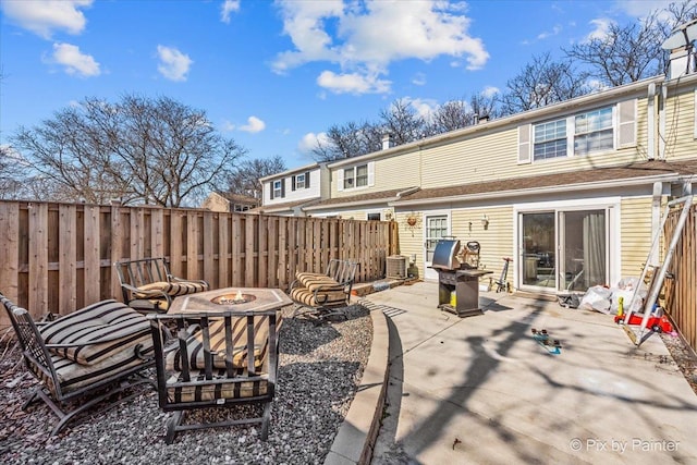 view of patio with a fire pit, central AC, and fence