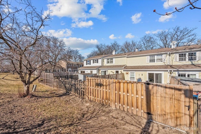 back of property featuring fence private yard and a chimney