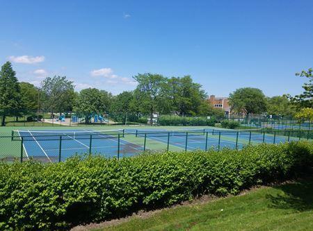 view of tennis court featuring fence