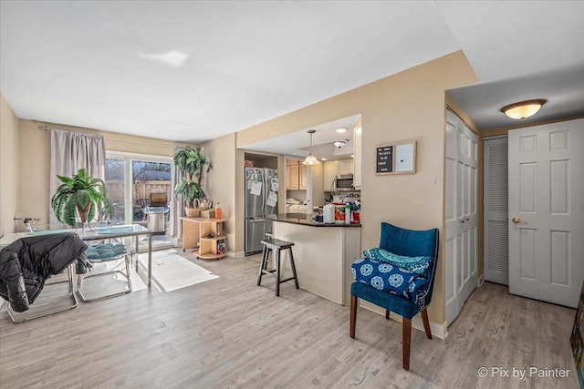 interior space with light wood-type flooring and baseboards