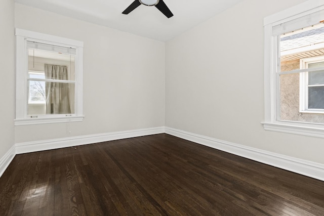 unfurnished room featuring baseboards, plenty of natural light, wood finished floors, and a ceiling fan