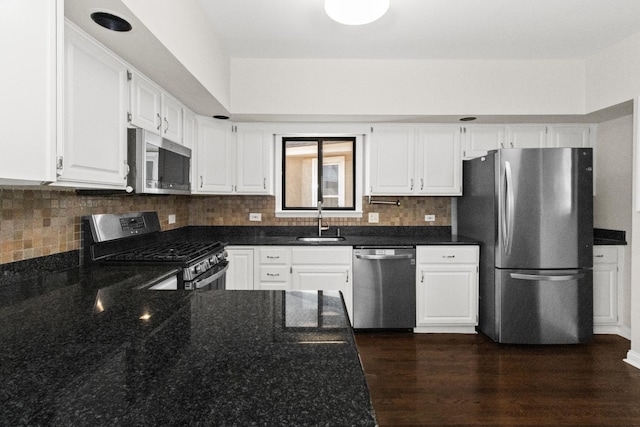 kitchen with white cabinets, tasteful backsplash, appliances with stainless steel finishes, and a sink