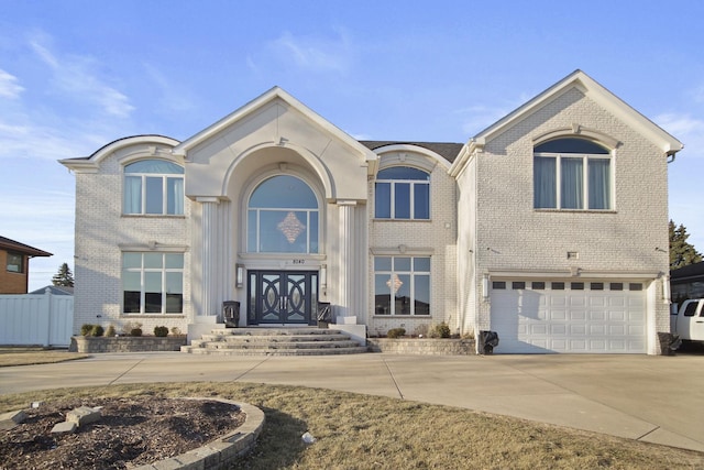 view of front of home with brick siding, an attached garage, and driveway