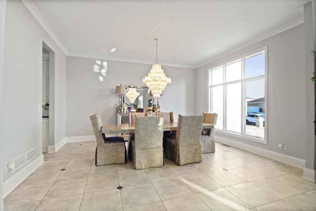 dining space featuring a wealth of natural light, visible vents, and ornamental molding