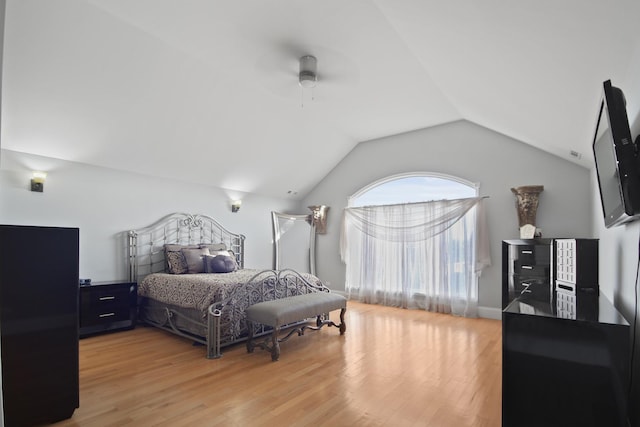 bedroom with vaulted ceiling, light wood-type flooring, and ceiling fan