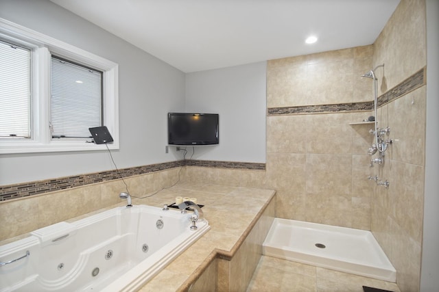 full bathroom with a tub with jets and a tile shower