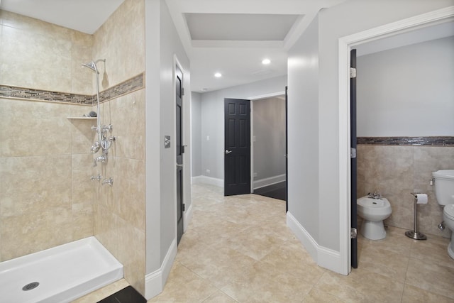 bathroom featuring toilet, a bidet, tile walls, a shower stall, and tile patterned flooring