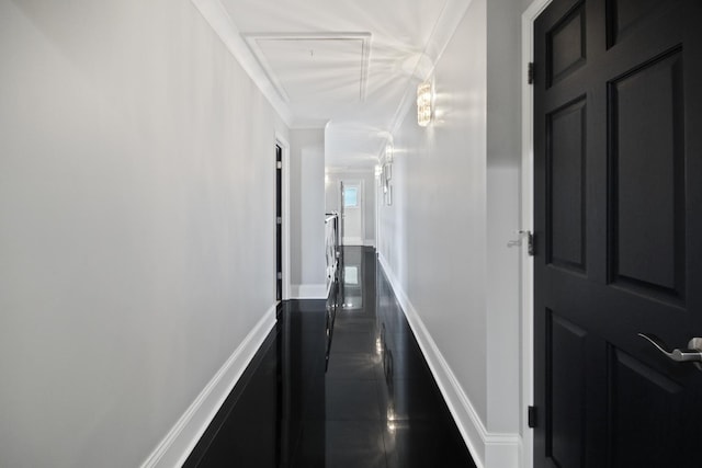 corridor with baseboards and ornamental molding