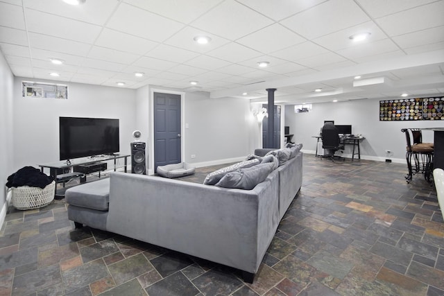 living room featuring stone tile floors, recessed lighting, baseboards, and a paneled ceiling