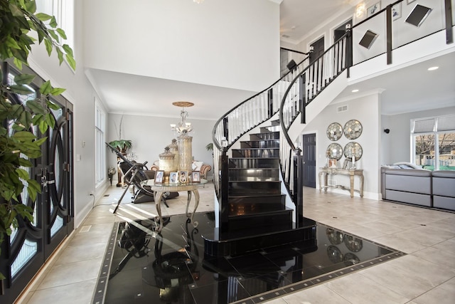 tiled foyer featuring visible vents, crown molding, stairs, and a towering ceiling