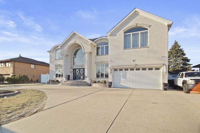 traditional-style home featuring an attached garage, brick siding, and driveway