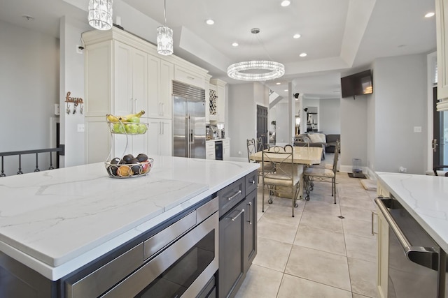 kitchen featuring recessed lighting, white cabinetry, a raised ceiling, and built in fridge