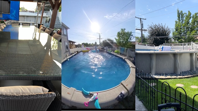 view of swimming pool with a fenced in pool and fence