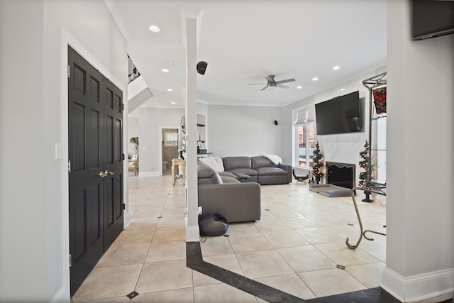 entrance foyer with a ceiling fan, recessed lighting, light tile patterned floors, a premium fireplace, and baseboards