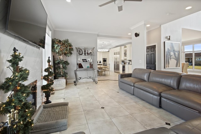 living area featuring light tile patterned floors, recessed lighting, a ceiling fan, and ornamental molding