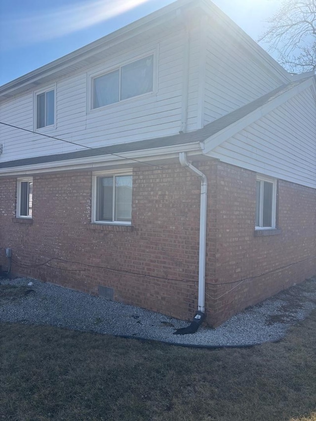 view of property exterior featuring brick siding