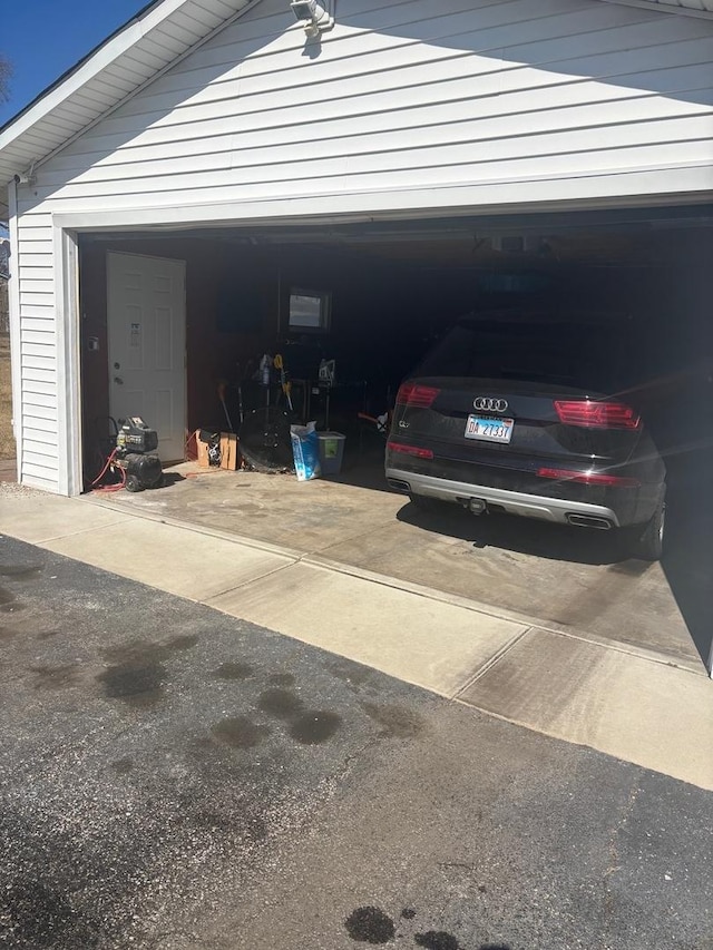 garage featuring concrete driveway