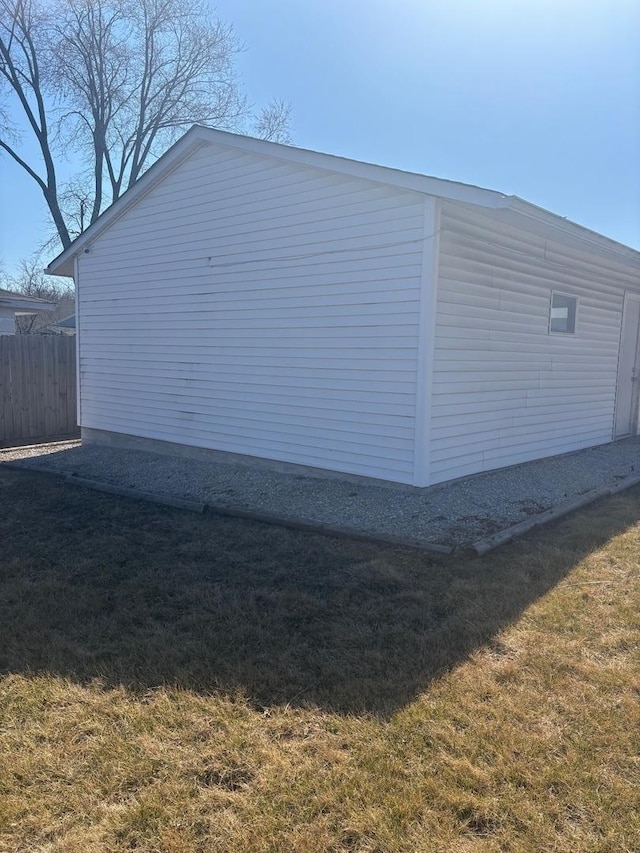 view of property exterior featuring a yard and fence