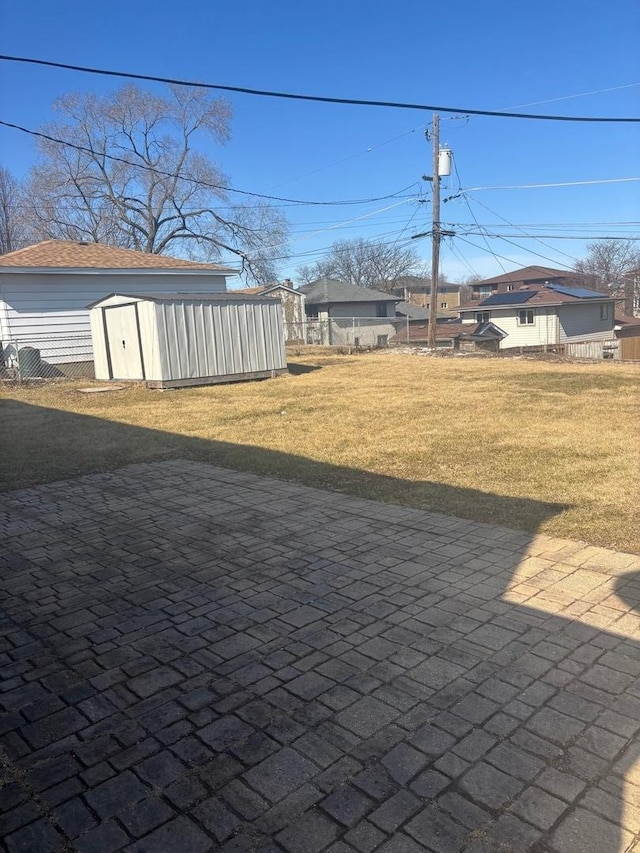 view of yard with a storage unit and an outbuilding